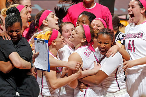 Rachel Banham is mobbed by teammates and staff after hitting the game-winning shot.