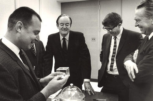Robert Pepin and three other men stand around a table with Hubert Humphrey.
