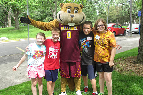 Some kids pose with Goldy Gopher.