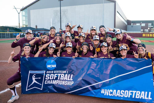 The Gopher softball team stands behind its Super Regional championship banner.