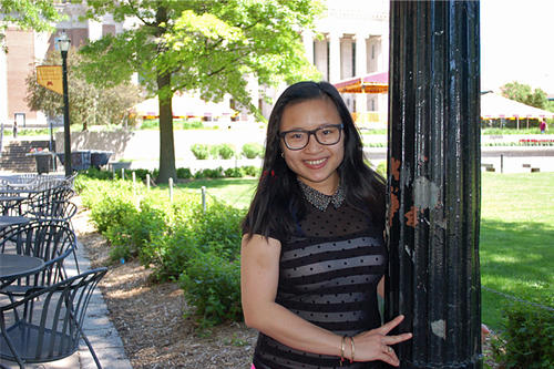 Trang Bui, in glasses, on Northrop Mall in warm weather.