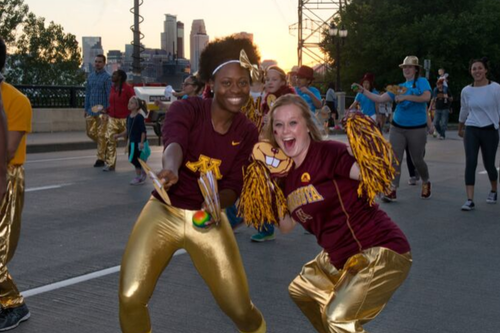 Two students at the Twin Cities campus&#039; homecoming parade.