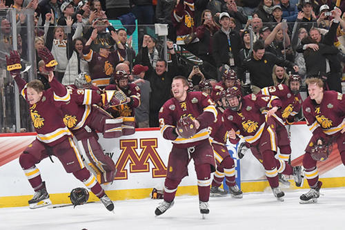UMD men&#039;s hockey players storm the ice after winning the Frozen Four title on April 7.