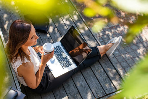 a woman on a laptop outside