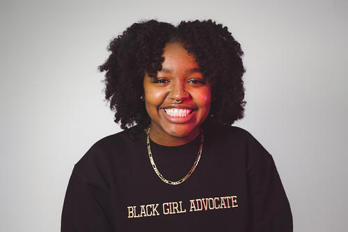 Shamaria Jordan in sweater reading "Black Girl Advocate"