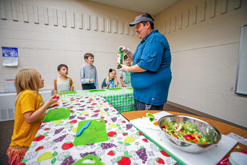 Erin Kiyukanpi demonstrates a stir-fry for kids at Taste Buds, a program that teaches children about food, nutrition, and cooking.