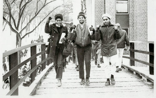 black students crossing bridge on campus