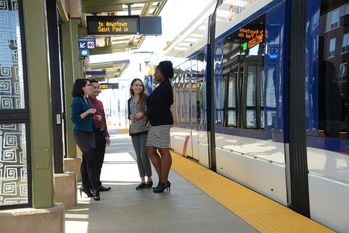 women at a metro transit stop